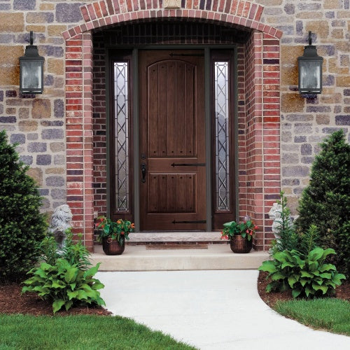 Wooden front door with glass panels on a brick house exterior